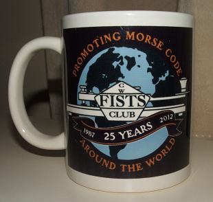 Photograph of the FISTS 25th Anniversary Mug with the full size black version of the anniversary logo
