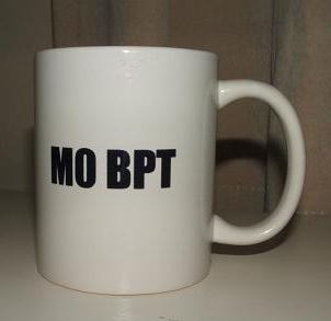 Photograph of the FISTS 25th Anniversary Mug with the reverse side showing M0BPT printed on it