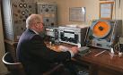 Small photograph of radio officer Hamish Taylor in the reconstructed ship's radio room at the Sandford Mill Museum, Chelmsford.