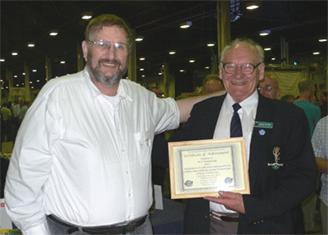 Photograph at Leicester 2006 of Rob Mannion G3XFD presenting Peter G4LHI with an Award recognising Peter's CW teaching achievements.