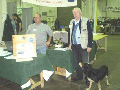 Photograph of Donnington 2008 FISTS stand showing John M0CDL, Derrick M0BDD and Derrick's dog Peggy.